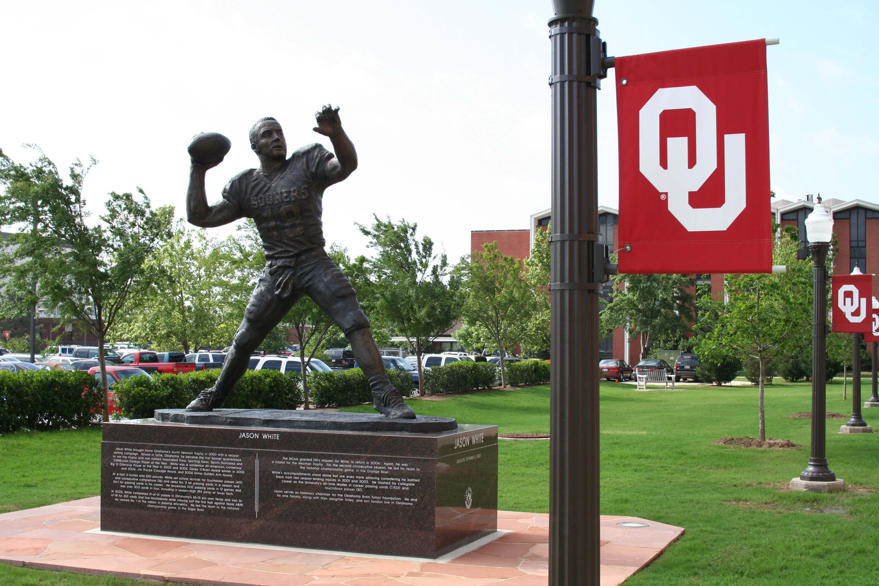 University of Oklahoma campus showing OU flag attached to a light pole