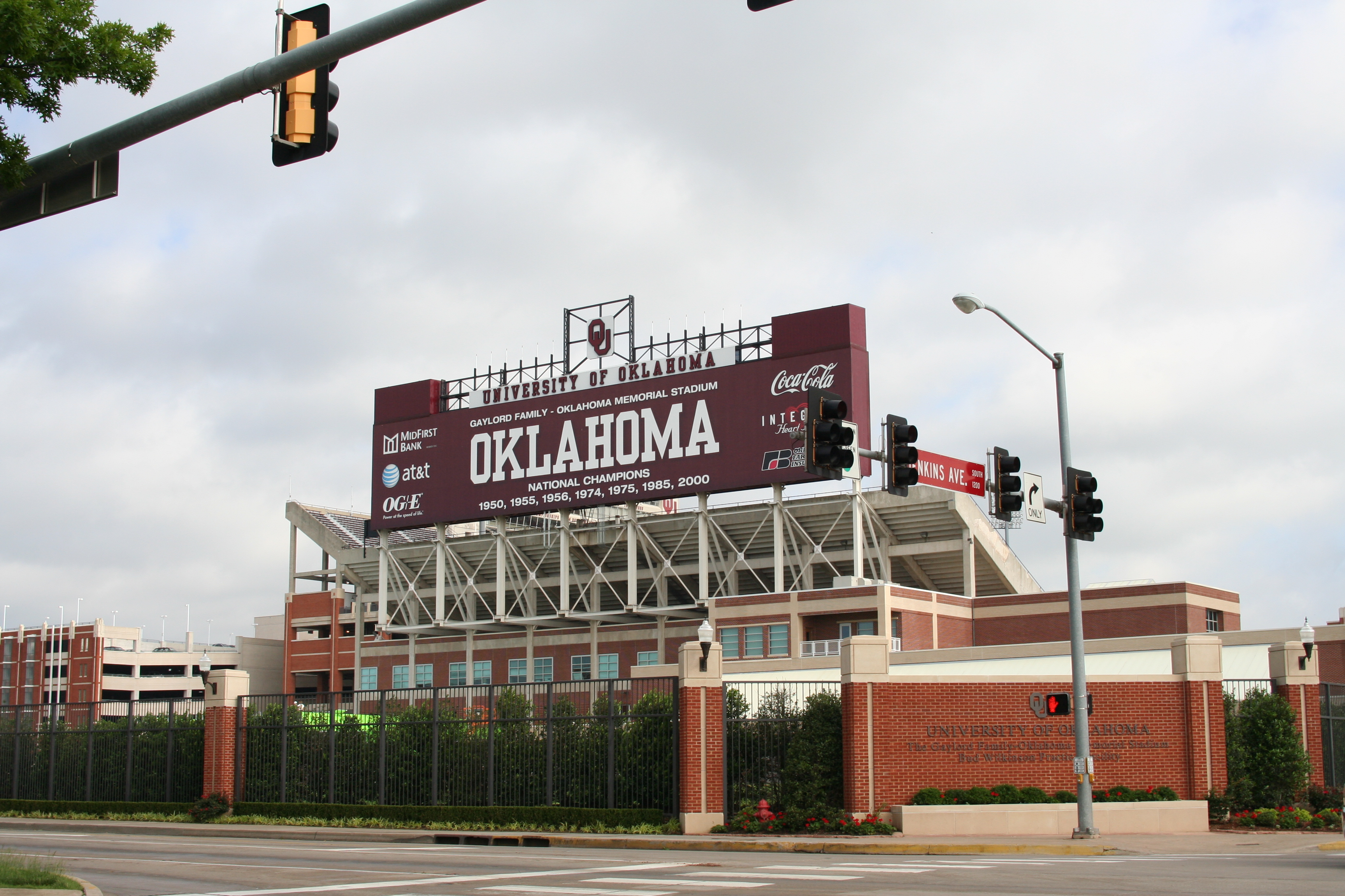 University of Oklahoma football stadium exterior showing giant signage covering the reverse of scoreboard indicating championships, etc.
